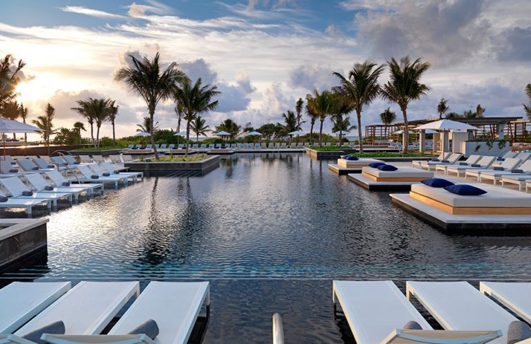 A Pool Area With Pool Beds and Chairs