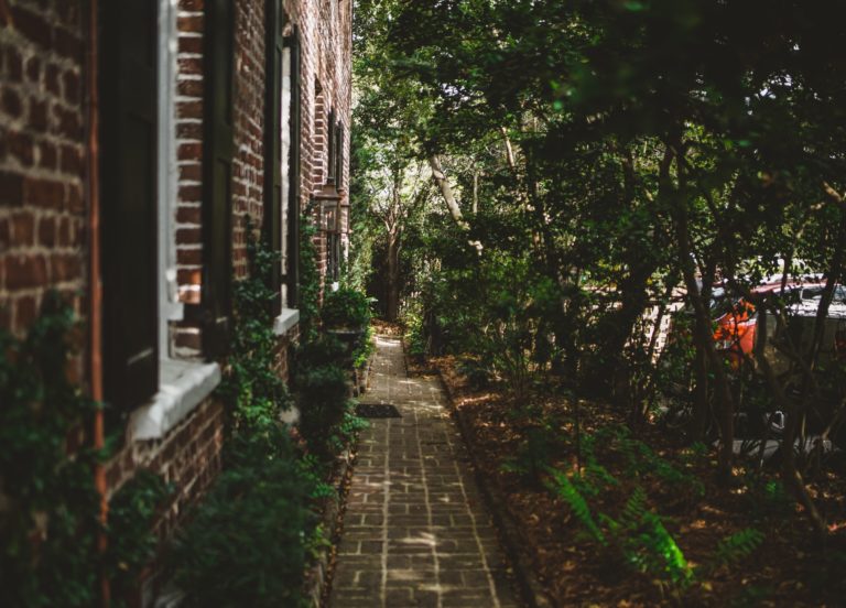 An Image of a Brick House With a Pathway