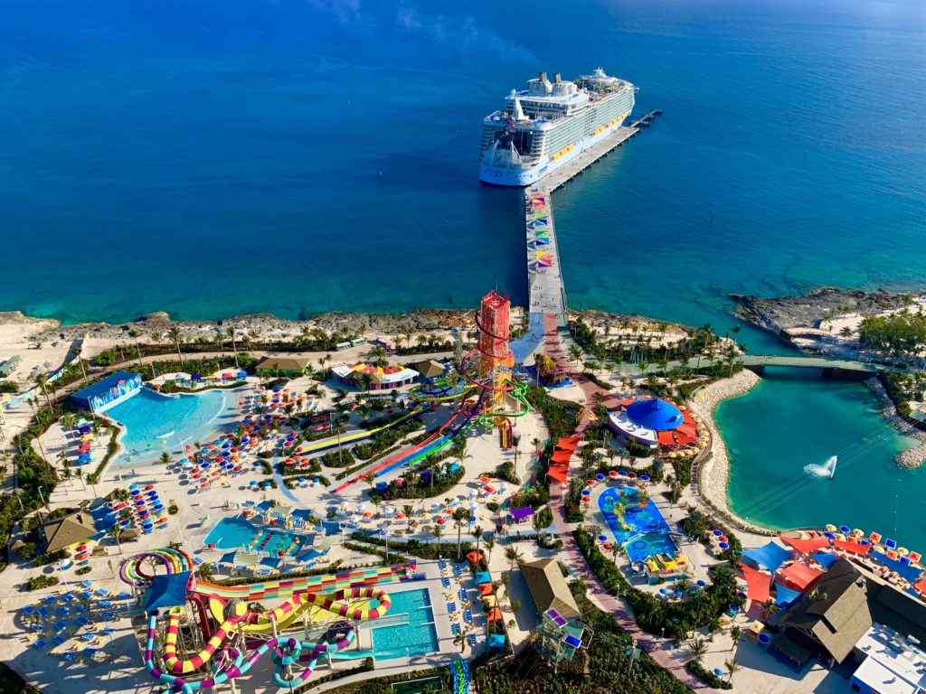 A Ship Stopping by a Amusement Park by the Beach